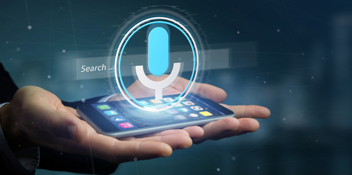 SEO in 2025: Smarter Strategies for Real Results 6 User speaking into a smartphone voice assistant to find local services through conversational and “near me” searches.